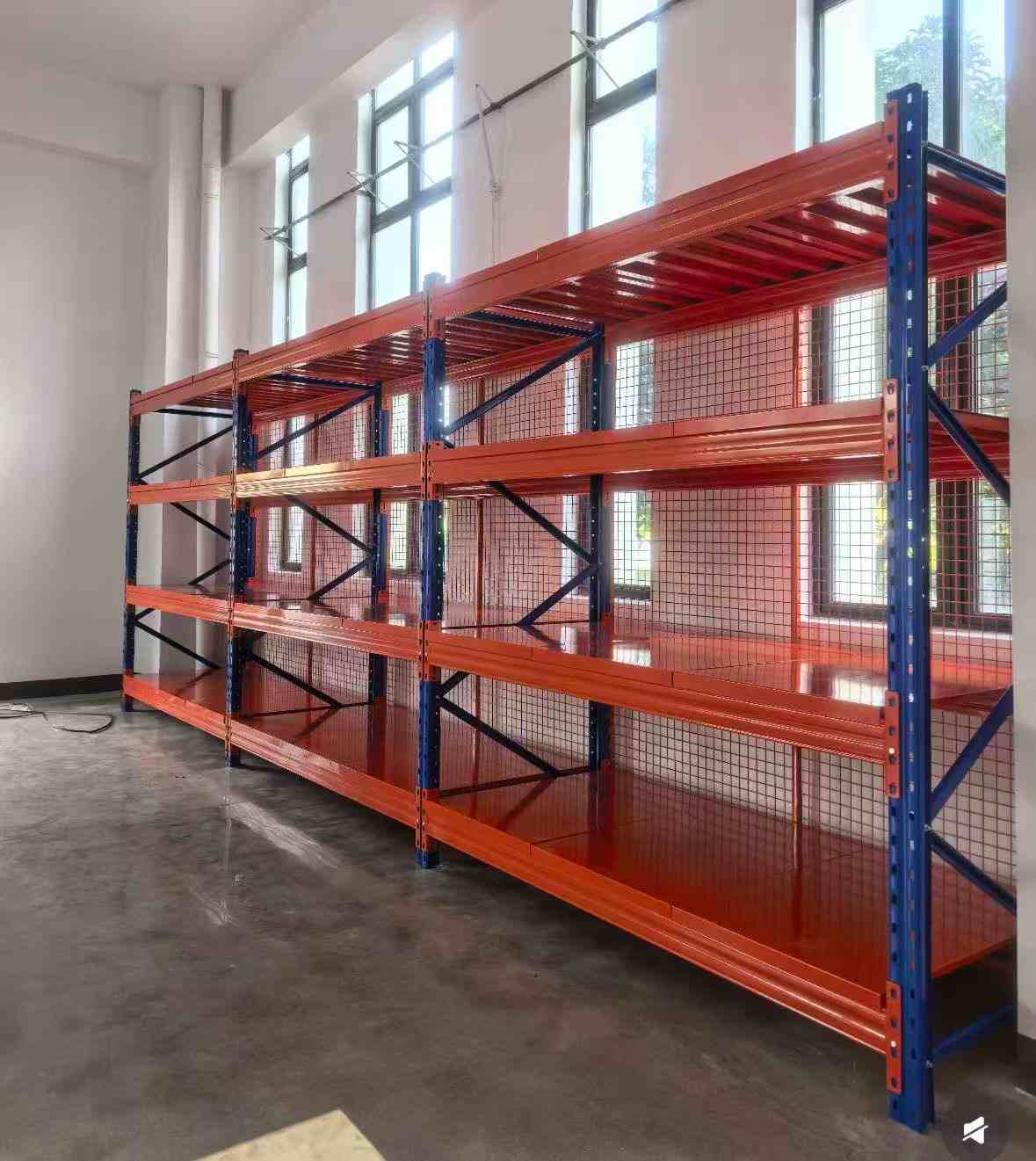Heavy duty warehouse shelving with reinforced blue frames and diagonal side bracing
