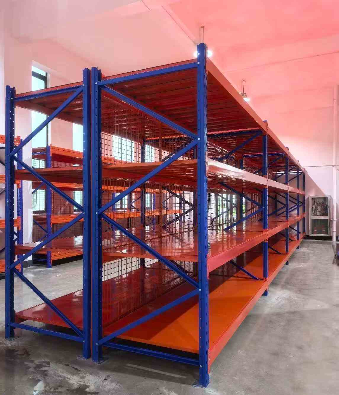 Adjustable steel storage racks arranged in a multi-bay warehouse shelving layout