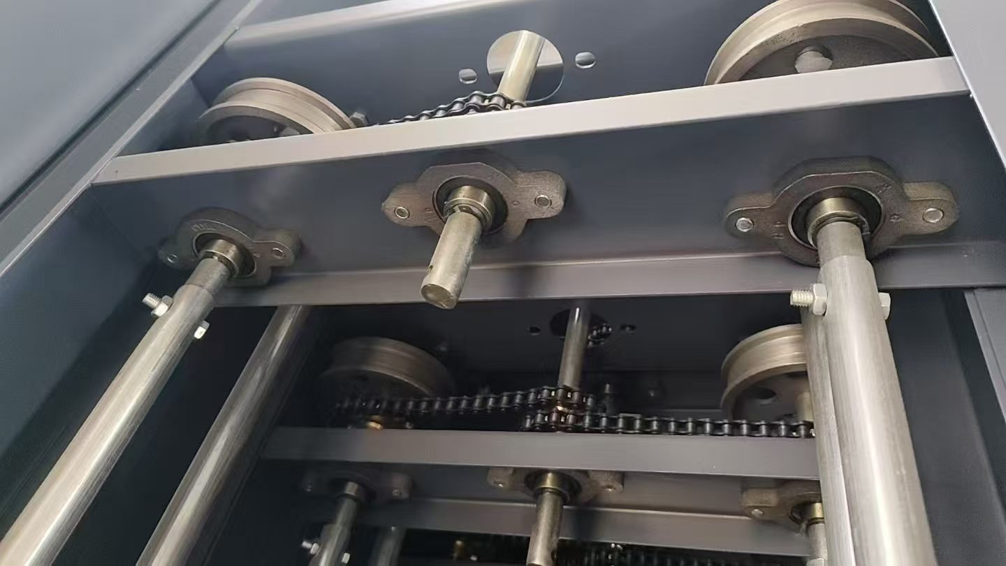 Multiple steel mobile shelving bases aligned on parallel floor tracks during installation
